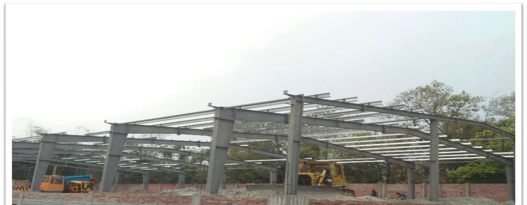 Steel frame erection in progress, industrial shed